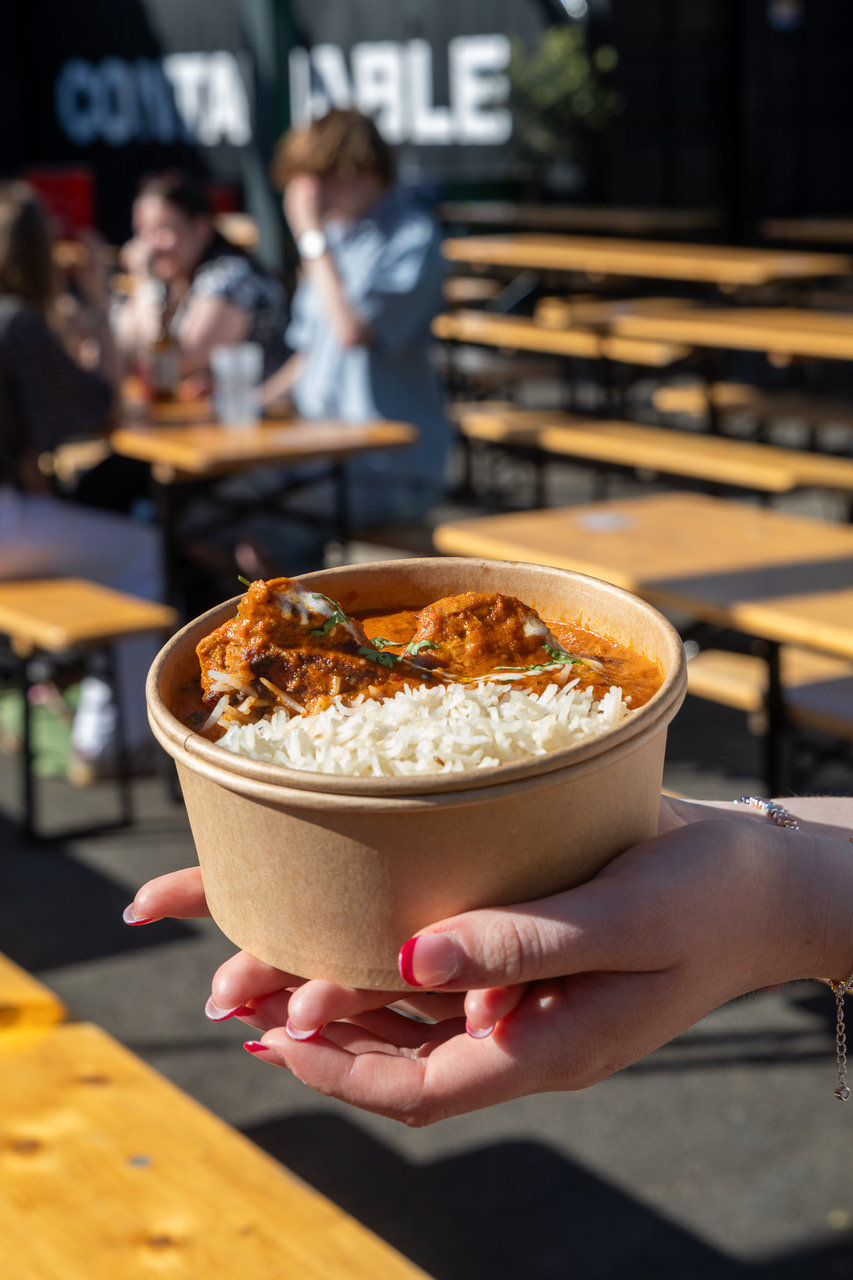 A bowl of Cegin Halfnhalf butter chicken and rice held at a festival in Wales